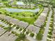 Beautiful aerial view of homes nestled alongside a pond and lush golf course at 2292 Sifield Greens Way # 59, Sun City Center, FL 33573