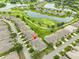 Stunning aerial view of a residential community featuring picturesque lakes, a golf course, and lush greenery at 2292 Sifield Greens Way # 59, Sun City Center, FL 33573