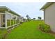 Lush green backyard with well-maintained lawn at 2292 Sifield Greens Way # 59, Sun City Center, FL 33573