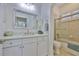 Bright bathroom featuring a shower-tub combination with a glass door, and a vanity with ample storage at 2292 Sifield Greens Way # 59, Sun City Center, FL 33573