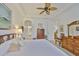 Bright bedroom featuring a ceiling fan, white walls, wood floors and stylish decor at 2292 Sifield Greens Way # 59, Sun City Center, FL 33573