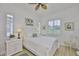 Bright bedroom with a ceiling fan, white furniture, and natural light at 2292 Sifield Greens Way # 59, Sun City Center, FL 33573