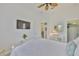 Bright bedroom with a ceiling fan, white furniture, and natural light at 2292 Sifield Greens Way # 59, Sun City Center, FL 33573