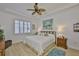 Inviting bedroom features a ceiling fan, plantation shutters and a comfortable bed at 2292 Sifield Greens Way # 59, Sun City Center, FL 33573