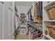 Well-organized walk-in closet features shelving, clothing racks, and woven baskets for optimal storage solutions at 2292 Sifield Greens Way # 59, Sun City Center, FL 33573