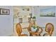 Bright dining area with a view into the modern kitchen featuring white cabinets and stainless steel appliances at 2292 Sifield Greens Way # 59, Sun City Center, FL 33573