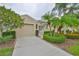 Charming home with a well-manicured lawn, beautiful landscaping, and a spacious two-car garage at 2292 Sifield Greens Way # 59, Sun City Center, FL 33573