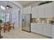 Bright kitchen boasts stainless steel appliances, white cabinetry, and breakfast nook area at 2292 Sifield Greens Way # 59, Sun City Center, FL 33573