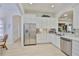 Modern kitchen with white cabinets, stainless steel appliances, and bright natural light at 2292 Sifield Greens Way # 59, Sun City Center, FL 33573