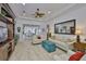 Bright and open living room features neutral tones, a ceiling fan, and a large mirror at 2292 Sifield Greens Way # 59, Sun City Center, FL 33573