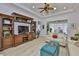 Comfortable living room with decorative built-ins, ceiling fan and view into sunroom at 2292 Sifield Greens Way # 59, Sun City Center, FL 33573