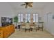 Bright and airy office features a ceiling fan, a desk in front of windows, and wood-look flooring at 2292 Sifield Greens Way # 59, Sun City Center, FL 33573