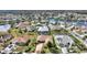 Aerial view showcasing a residential neighborhood, highlighting a home with a swimming pool in a lakeside community at 2359 Emerald Lake Dr, Sun City Center, FL 33573