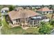 Tranquil backyard featuring a screened lanai, well-manicured lawn, and tropical landscaping at 2359 Emerald Lake Dr, Sun City Center, FL 33573