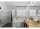 Bathroom with a glass enclosed shower, tub, and granite vanity with double sinks at 2359 Emerald Lake Dr, Sun City Center, FL 33573