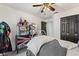 Bedroom featuring a ceiling fan, a dollhouse display, and black closet doors at 2359 Emerald Lake Dr, Sun City Center, FL 33573