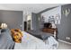 Comfortable bedroom featuring gray walls, a large dresser, and stylish decor at 2359 Emerald Lake Dr, Sun City Center, FL 33573