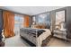 Stylish bedroom with gray walls, orange curtains, and an ornate white iron bed frame at 2359 Emerald Lake Dr, Sun City Center, FL 33573