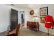 Bedroom area featuring an antique chest, an open door, and neutral colored walls and carpeting at 2359 Emerald Lake Dr, Sun City Center, FL 33573