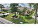 Well-maintained home showcases lush landscaping, palm trees, and a manicured lawn at 2359 Emerald Lake Dr, Sun City Center, FL 33573