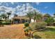 Beautiful home with a brick driveway, manicured lawn, and decorative landscaping, providing a welcoming entrance at 2359 Emerald Lake Dr, Sun City Center, FL 33573
