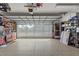 Spacious garage featuring epoxy flooring, a pegboard wall organizer and translucent panels on the garage door at 2359 Emerald Lake Dr, Sun City Center, FL 33573