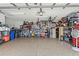 Spacious garage with epoxy floors, ample shelving and storage, and fluorescent lighting at 2359 Emerald Lake Dr, Sun City Center, FL 33573