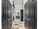 Hallway featuring black closet doors, checkered floors, and access to the bathroom at 2359 Emerald Lake Dr, Sun City Center, FL 33573