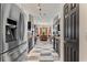 Galley kitchen with black cabinetry, stainless steel appliances, and checkered tile flooring at 2359 Emerald Lake Dr, Sun City Center, FL 33573