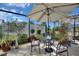 Enclosed patio space with outdoor seating, plants, and bright sunlight at 2359 Emerald Lake Dr, Sun City Center, FL 33573