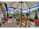 Screened in patio featuring patio furniture, decorative statuary, and lush landscaping at 2359 Emerald Lake Dr, Sun City Center, FL 33573