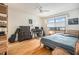 Cozy bedroom featuring hardwood floors, a ceiling fan, and a large window that provides plenty of natural light at 2368 Flanders Way # D, Safety Harbor, FL 34695