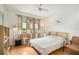 Inviting bedroom with wood floors, neutral tones, soft lighting, and large windows for a bright, airy feel at 2368 Flanders Way # D, Safety Harbor, FL 34695