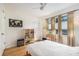 Bedroom featuring wooden floors and a large window that offers ample natural light and closet with white door at 2368 Flanders Way # D, Safety Harbor, FL 34695