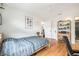 Comfortable bedroom boasts wood floors, closet, and a view into the en-suite bathroom, offering convenience at 2368 Flanders Way # D, Safety Harbor, FL 34695