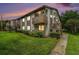 Exterior view of a well-kept two-story residential building with green lawn and manicured bushes at 2368 Flanders Way # D, Safety Harbor, FL 34695