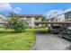 Exterior view of the property, showcasing well-maintained landscaping and assigned parking spots at 2368 Flanders Way # D, Safety Harbor, FL 34695