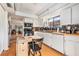 White kitchen featuring updated appliances, wooden countertops, and a seamless transition to the dining area at 2368 Flanders Way # D, Safety Harbor, FL 34695