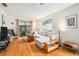 Living room features wood floors, a white couch and view of the lanai at 2368 Flanders Way # D, Safety Harbor, FL 34695