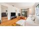 Living room with hardwood floors, white sofa, and access to the lanai at 2368 Flanders Way # D, Safety Harbor, FL 34695