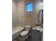 Cozy bathroom with a tub, toilet, and marble-topped vanity providing modern amenities at 2404 Cassell St, Tampa, FL 33605
