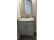 Compact bathroom featuring a vanity with a marble countertop and gold hardware accents at 2404 Cassell St, Tampa, FL 33605