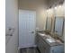 Elegant bathroom with dual sink vanity and framed mirrors at 2404 Cassell St, Tampa, FL 33605