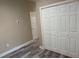 Bedroom featuring wood floors and a closet, providing ample storage space at 2404 Cassell St, Tampa, FL 33605