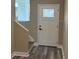 A welcoming entrance featuring a windowed door and hardwood stairs at 2404 Cassell St, Tampa, FL 33605