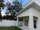 View of the back of a home with a white fence at 2404 Cassell St, Tampa, FL 33605