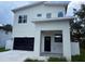 Modern two-story home with a black garage door and neutral-colored stucco exterior at 2404 Cassell St, Tampa, FL 33605