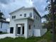 Modern, two-story home with a two-car garage and a white fence at 2404 Cassell St, Tampa, FL 33605