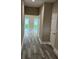 Inviting hallway with light walls, white trim, and wood-look flooring at 2404 Cassell St, Tampa, FL 33605