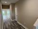 Entry hallway featuring luxury vinyl plank flooring and neutral color palette at 2404 Cassell St, Tampa, FL 33605